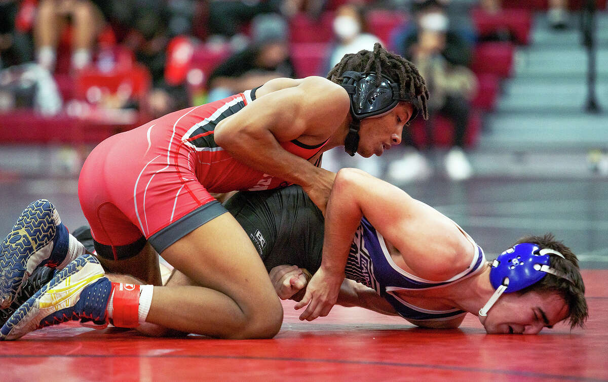 Alton's Deontae Forest holds Bloomington's Cayden Ayers to the mat Wednesday in their 132-pound bout during action in the "Red" Schmitt Tournament at Granite City High School. Forest won by major decision 11-1 and was 3-1 on the day.