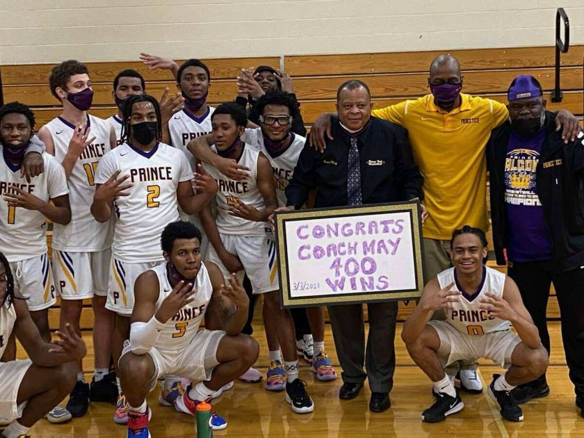 Prince Tech coach Kendall May (shirt and tie) is surrounded by his fellow coaches and players after May won his 400th career game on March 3, 2021.