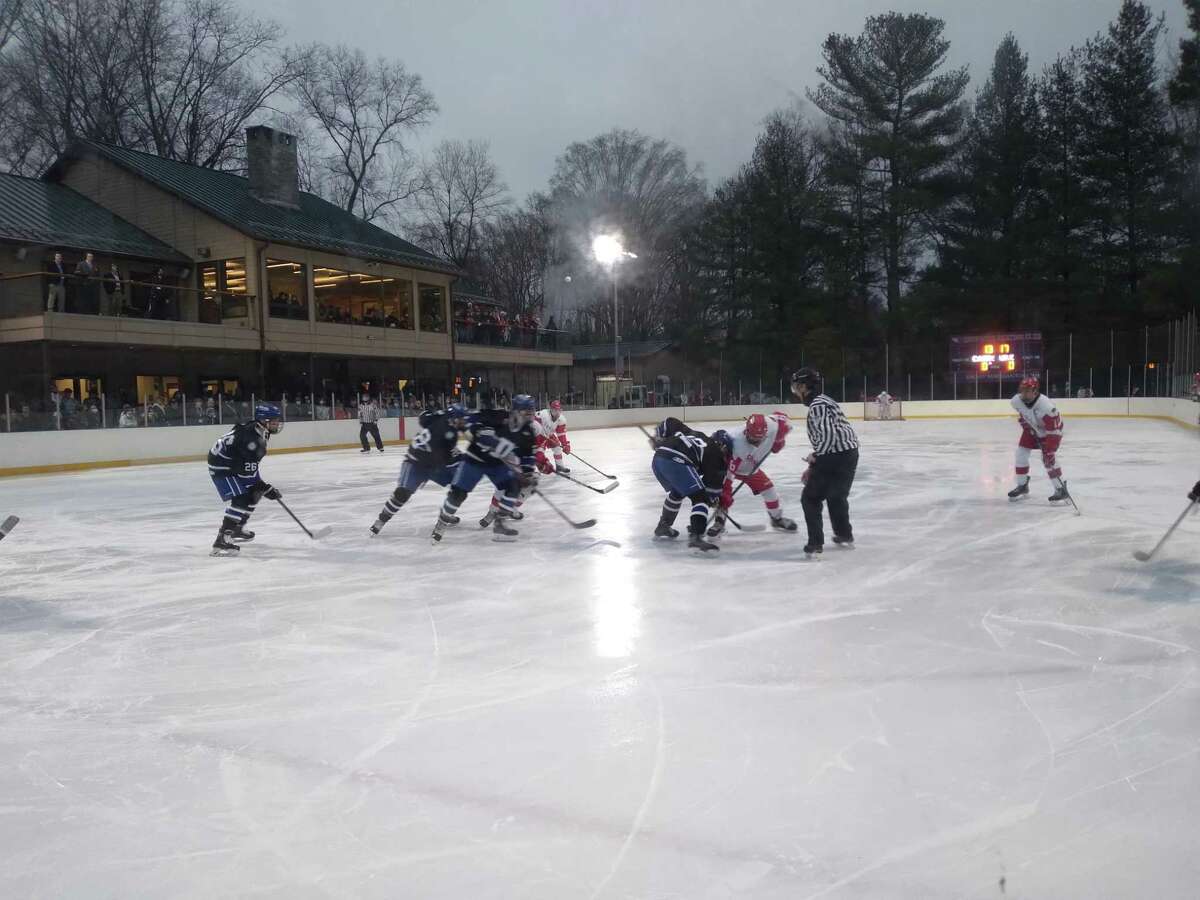 Darien (in black) and Greenwich line up for a first-period faceoff in the Winter Classic at Greenwich Skating Club on Wednesday. Darien won 4-2.