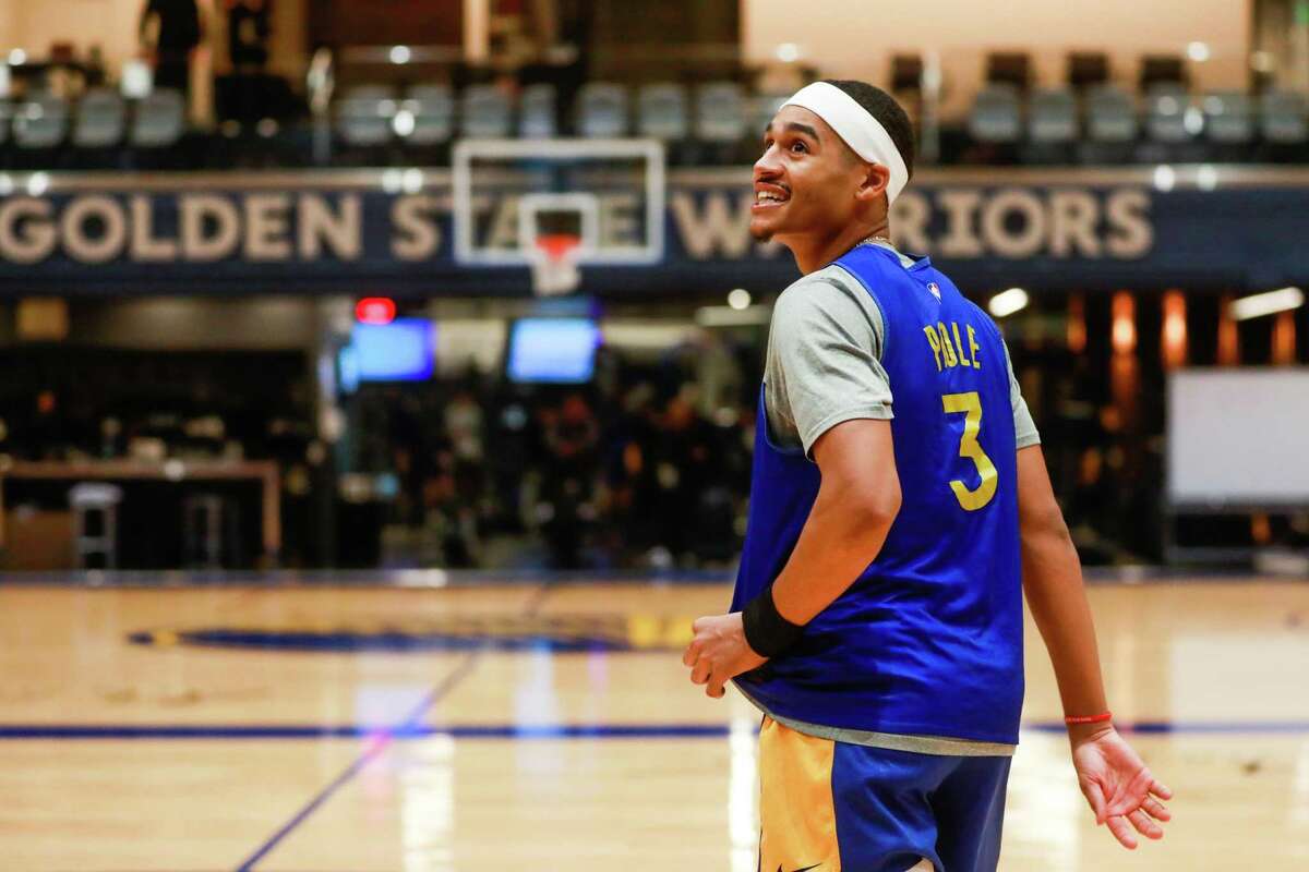 Golden State Warriors player Jordan Poole (3) smiles as he watches a teammate shoot during the Warriors practice at Chase Center on Tuesday, Dec. 7, 2021 in San Francisco, California.
