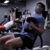 Yiming Jen tries to work out 6 days a week at Fitness SF on Fillmore Street in San Francisco, Calif., on Wednesday, December 29, 2021. As a member, he currently is not required to wear a mask, but does anyways. Starting on December 30th, he will have no choice.
