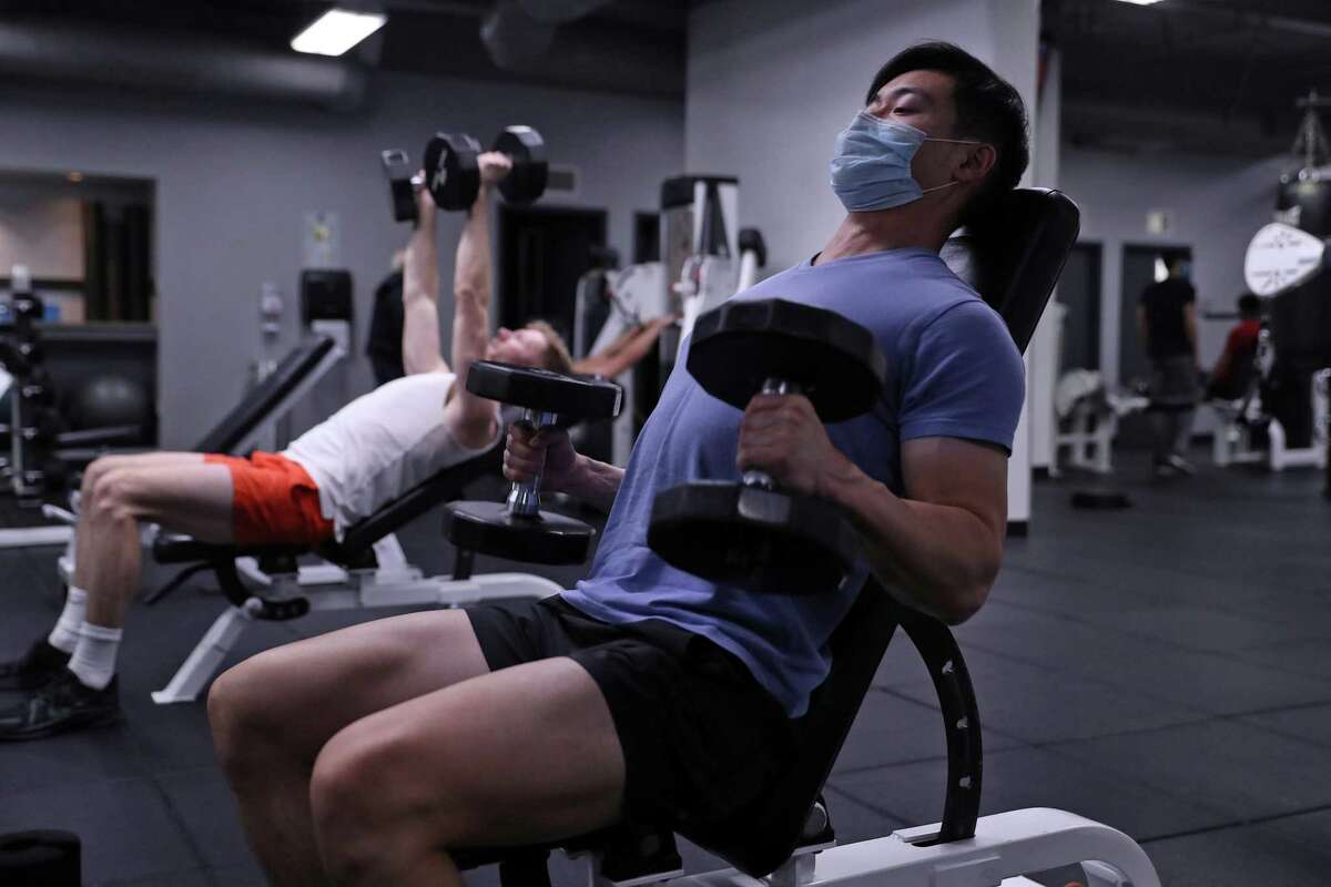 Yiming Jen tries to work out six days a week at Fitness SF on Fillmore Street in San Francisco. As a member, he was able to stop wearing a mask prior to the arrival of the omicron variant but had to put one back on starting Dec. 30. Now, masks can come off again as of Feb. 1.