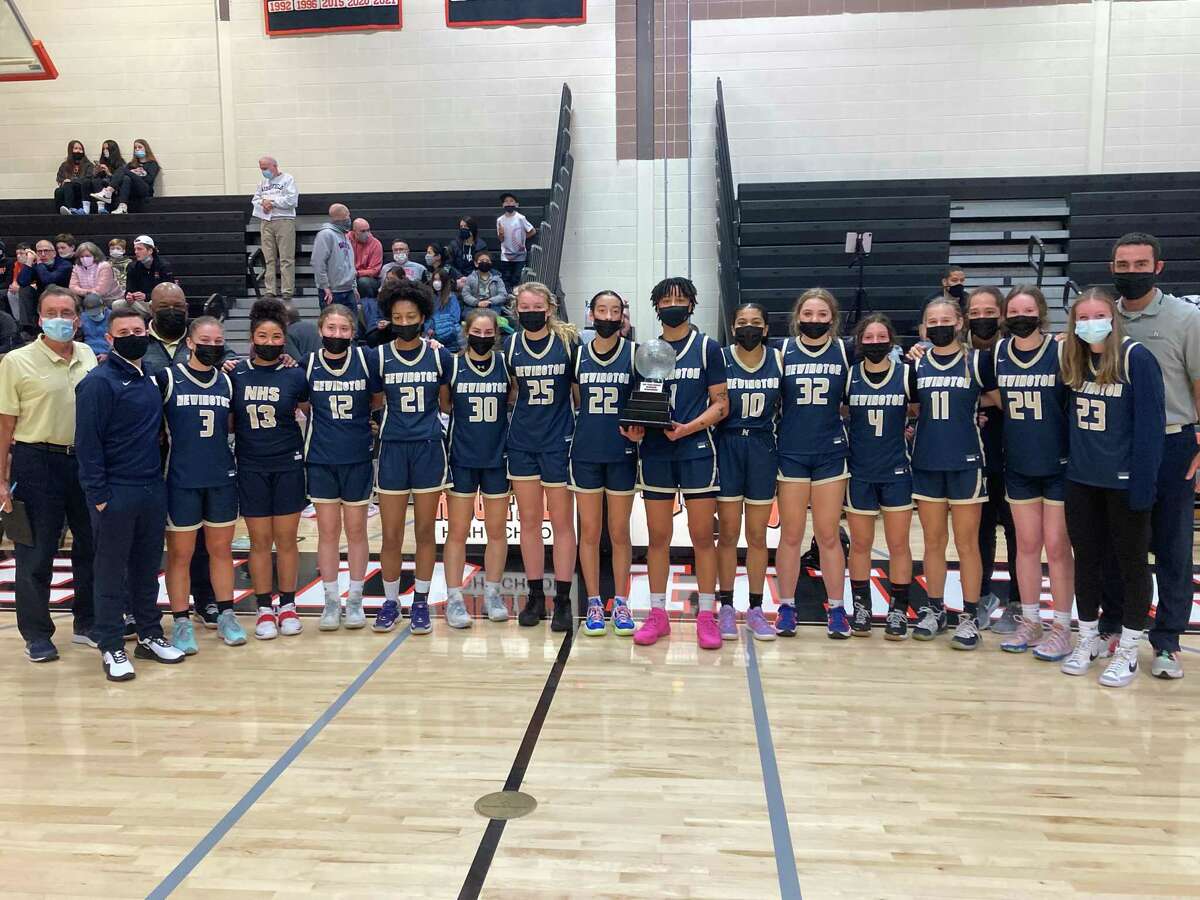Members of the Newington girls basketball team celebrate after defeating host Ridgefield in the first Tyler Ugolyn Memorial tournament Wednesday.
