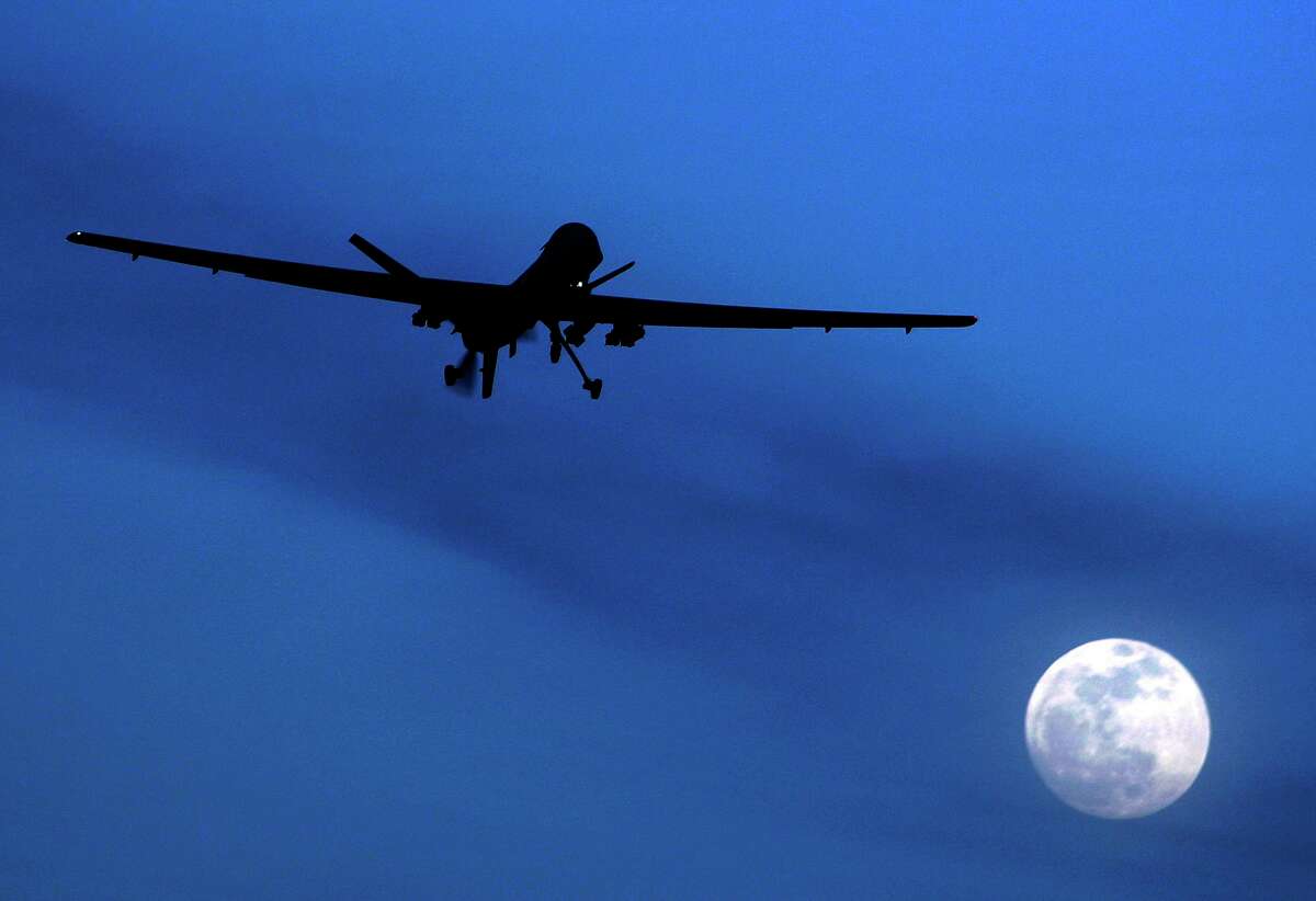 In this Jan. 31, 2010, an unmanned U.S. Predator drone flies over Kandahar Air Field, southern Afghanistan, on a moon-lit night.