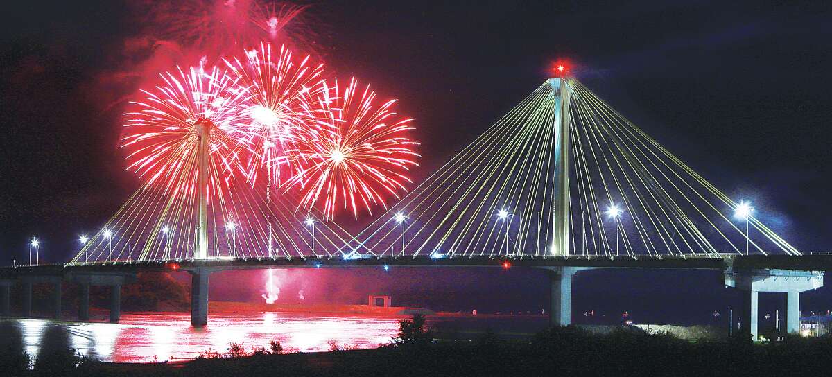 John Badman|The Telegraph Fireworks explode behind the Clark Bridge in Alton. Thousands came out to watch downtown and along the top of the levee in Alton during the Thursday night shows this summer and on July 3.