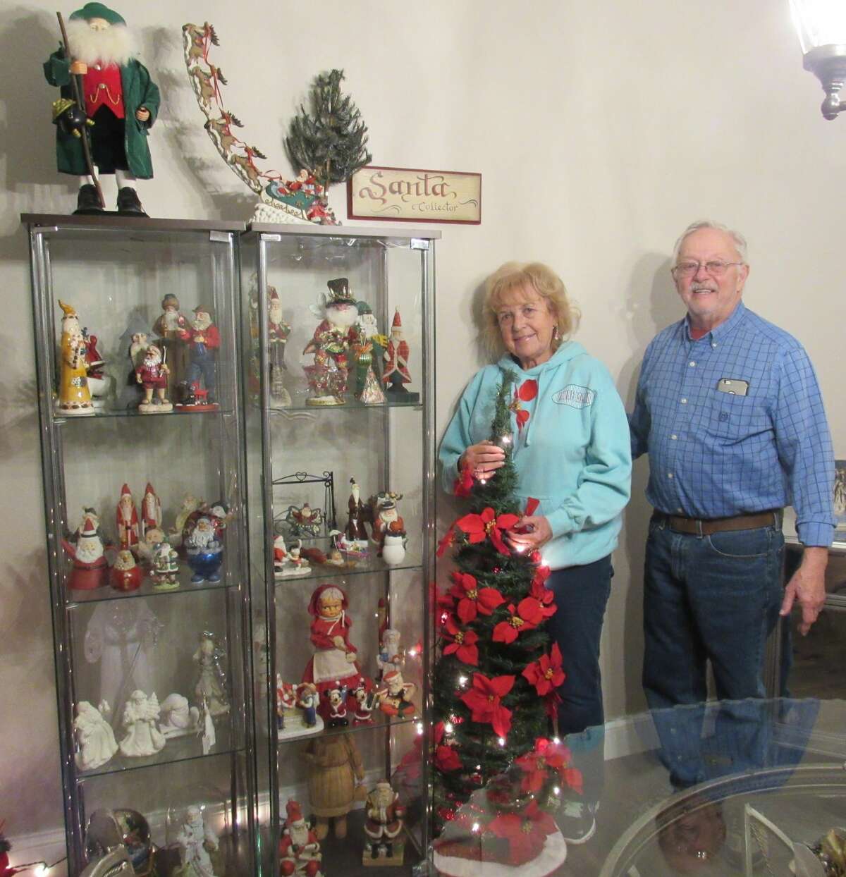 Sheila and Bob MacLaughlin with part of the collection of 120 Santas that decorate their home and star in their competition every Christmas. 