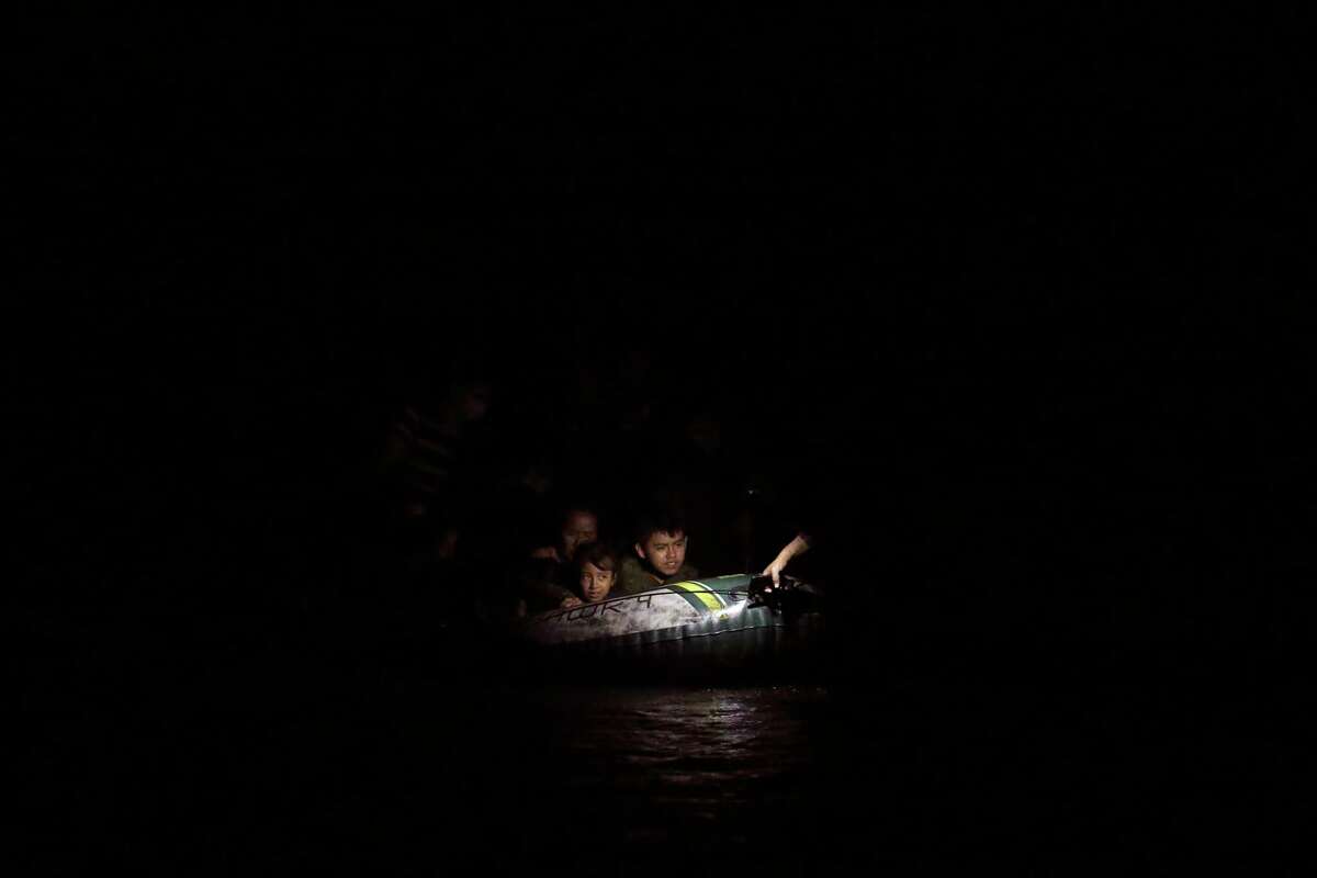 Young migrants are seen on a raft pulled by a smuggler across the Rio Grande into the U.S. at a crossing point in Roma, Texas, Wednesday, Aug. 11, 2021. Three different smuggling operations were seen crossing mostly Central American migrants at the site. One of the smugglers claimed he had around 180 people to cross.