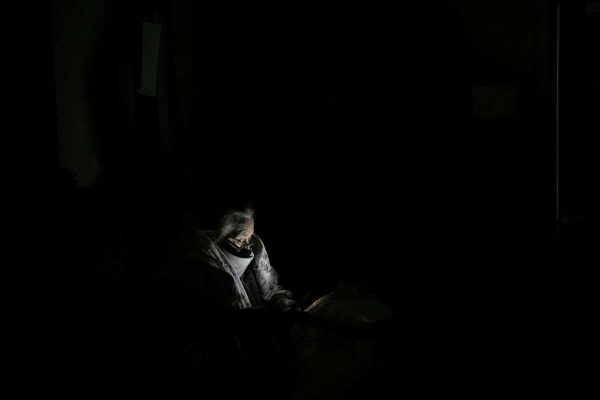 A Fair Avenue Apartments resident waits in a hallway for VIA buses to arrive to transport residents to the Grand Hyatt hotel downtown late Tuesday night after living without water and electricity for days in San Antonio on Feb. 16, 2021.