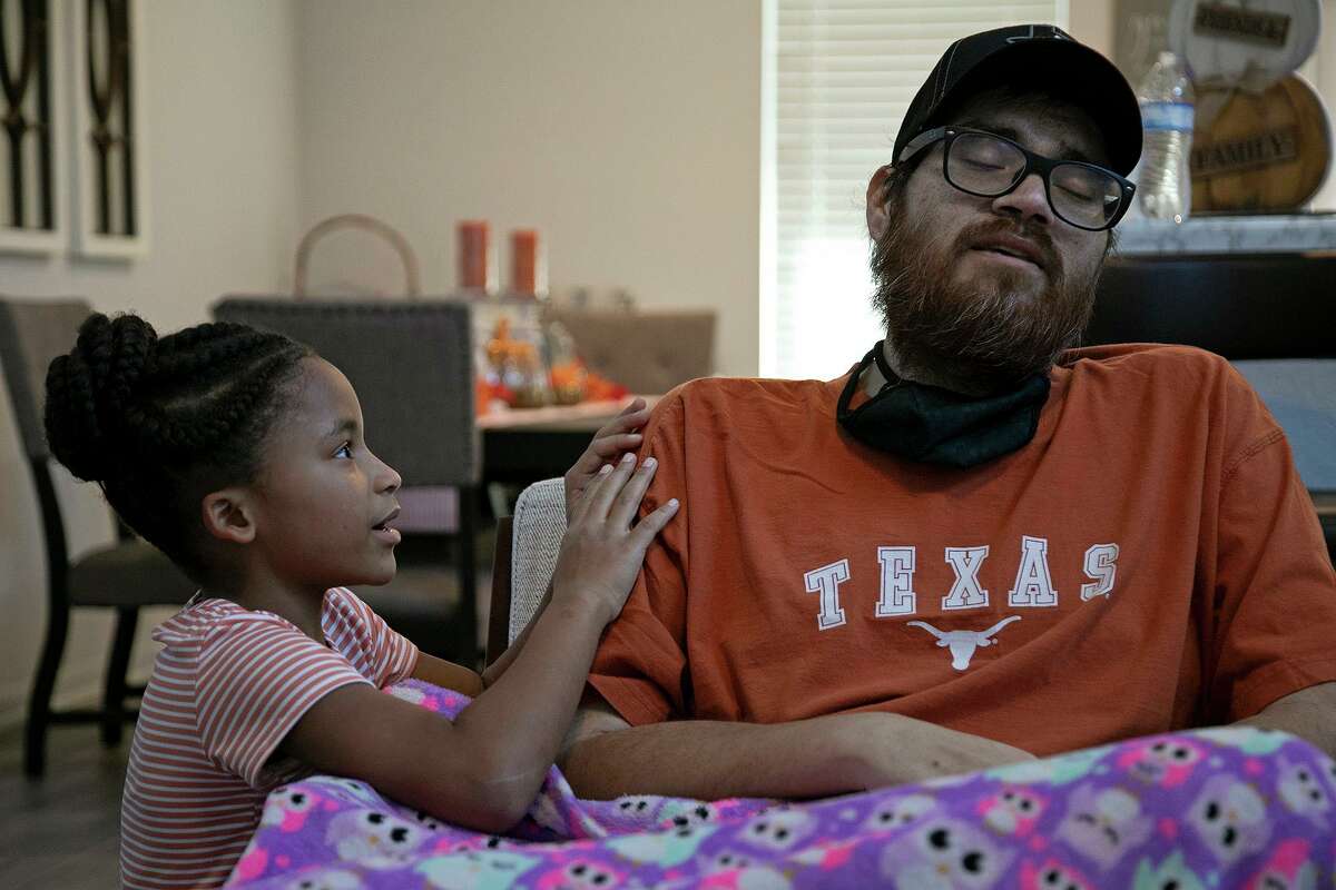 Mariah, 8, dotes on her father, John Vargas Jr. as she sees him for the first time since his transplant when he arrived home in San Antonio on October 23, 2020.