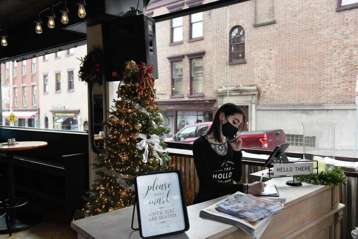A reservation is taken at The Hollow Bar and Kitchen on Thursday, Dec. 30, 2021, in Albany, N.Y.