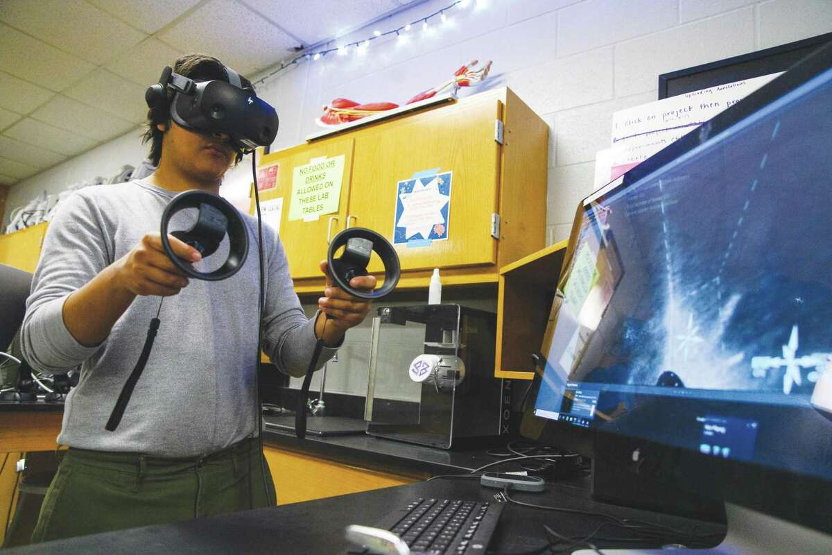 New Tech senior Octavio Garcia, 17, demonstrates their research within a program called SyGlass using a Steam VR headset following an interview about the school’s neuroscience program Tuesday afternoon at New Tech Odessa.