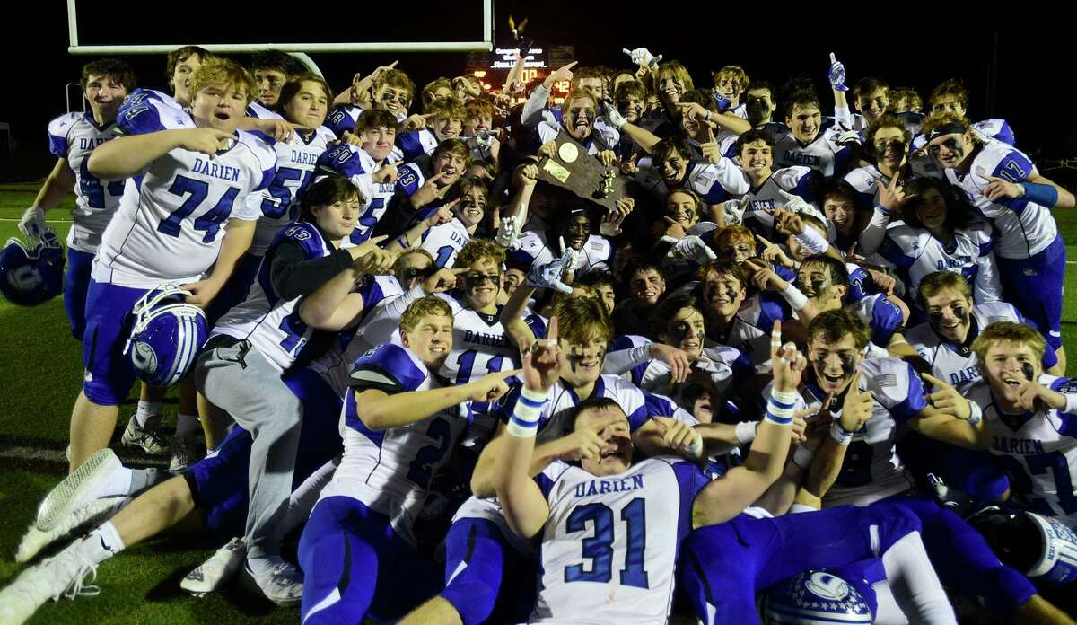 The Blue Wave celebrates their win following their win in the Class LL state championship between No. 1 Fairfield Prep Jesuits and No. 3 Darien High School Blue Wave Saturday, December 11, 2021, at Trumbulll High School in Trumbull, Conn.