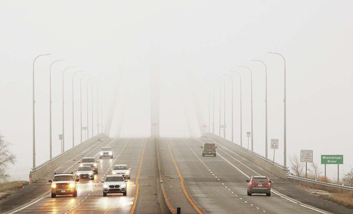 John Badman|The Telegraph Fog had the entire Riverbend socked in pretty good Thursday morning as motorists crossing the Clark Bridge in Alton knew as they watched the bridge they just crossed disappear behind them. River traffic appeared to have stopped all morning until the fog lifted enough to make conditions safe for movement. Visibility was less than a quarter mile across the region as the fog hung close to the ground. Fog occurs when air containing a great deal of moisture condenses low to the ground. Fog is essentially a cloud that touches the ground. New Year's Eve is predicted to be a balmy 64 degrees before snow, or a wintery mix, moves into the area New Year's Day and into Sunday.