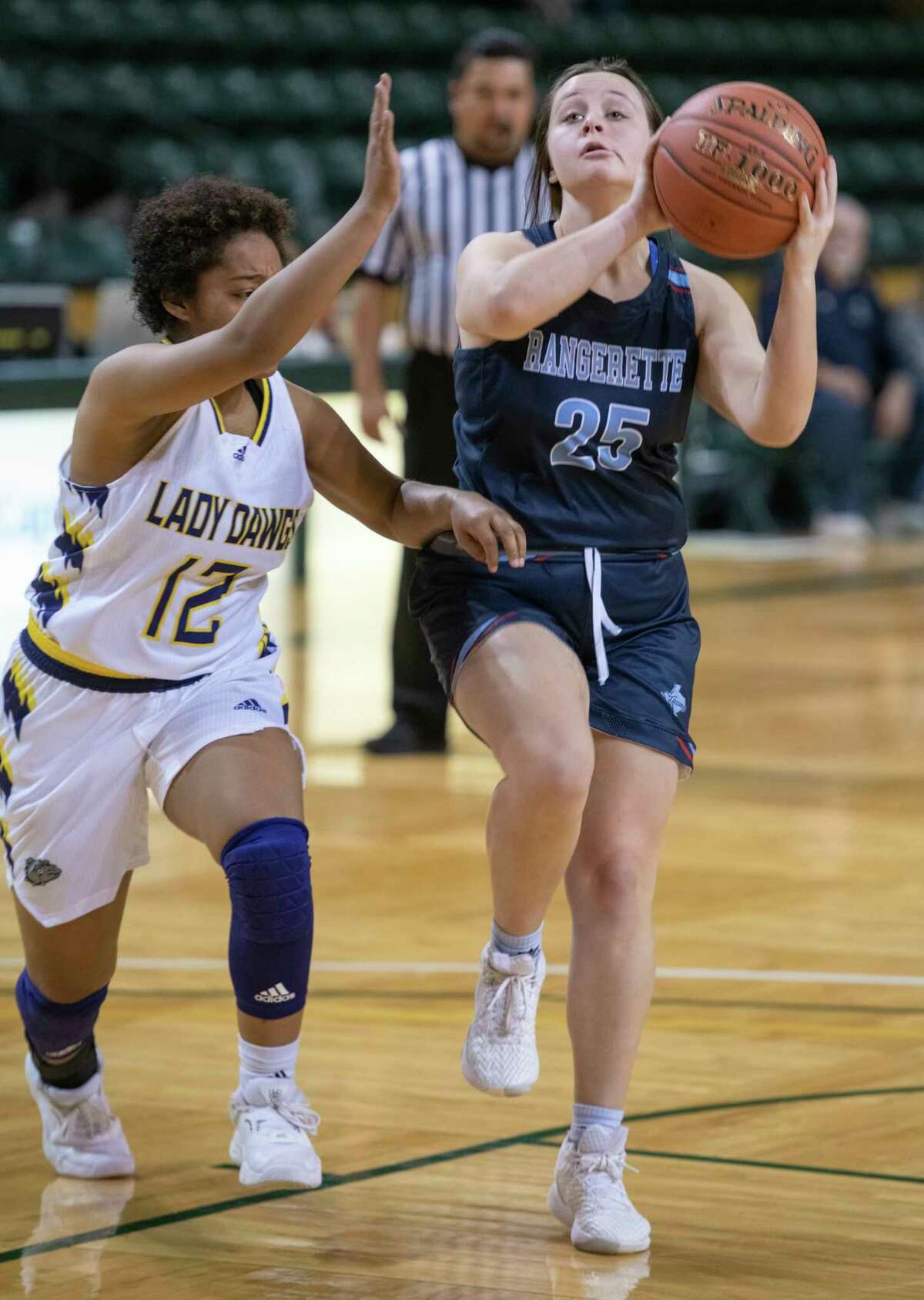 Greenwood's Grace Gardenhire drives to the basket as Midland High's Jewel Hubert defends 12/30/2021 during the Byron Johnston Holiday Classic at the Chaparral Center. Tim Fischer/Reporter-Telegram
