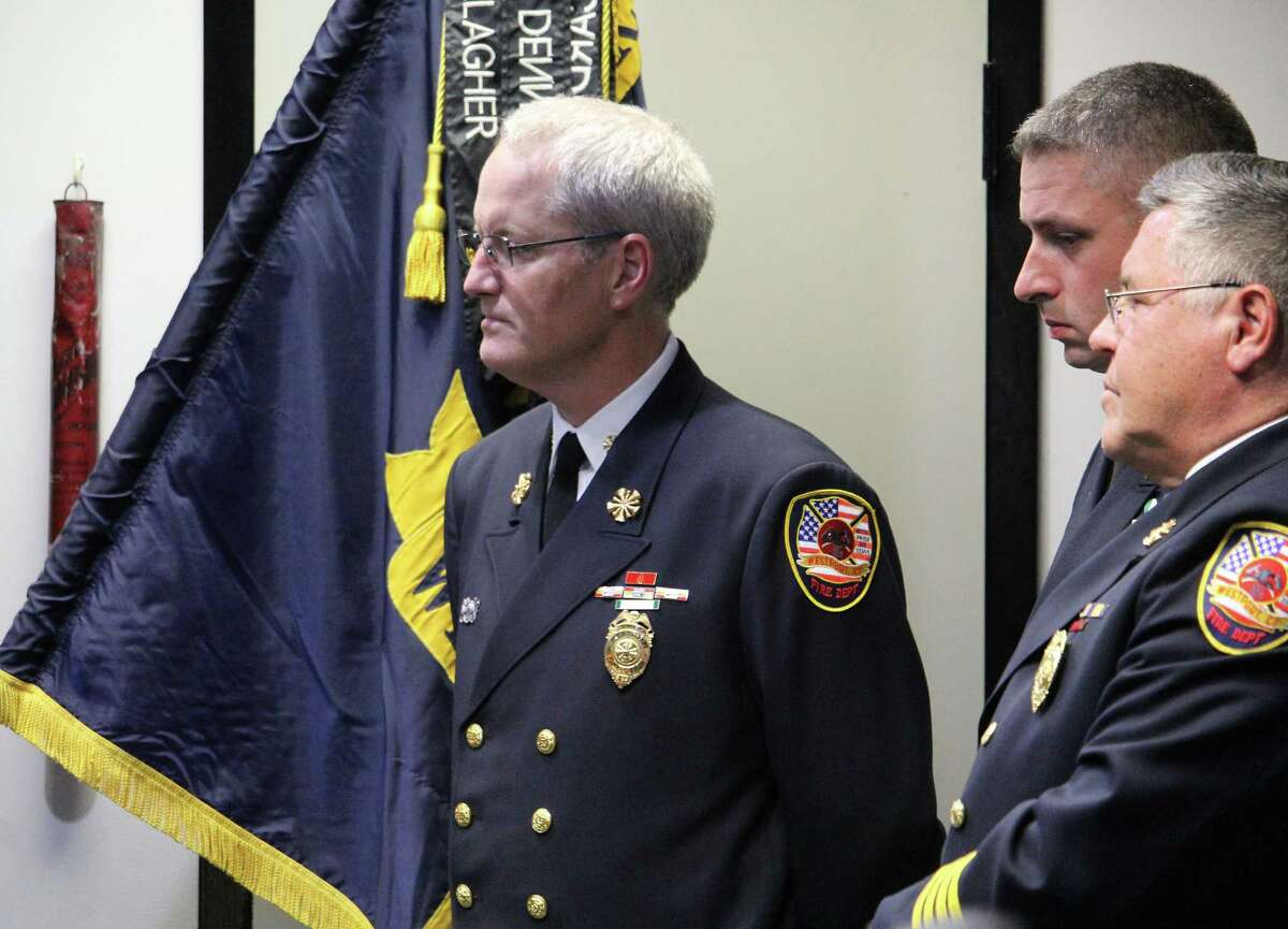 Fire Chief Robert Yost oversees a swearing-in ceremony for five new firefighters at fire headquarters in Westport, Conn. on Aug. 18, 2017.