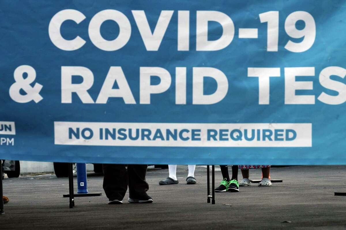 People wait to get tested for COVID-19 at a pop-up testing site in Los Angeles, Monday, Dec. 20, 2021. 