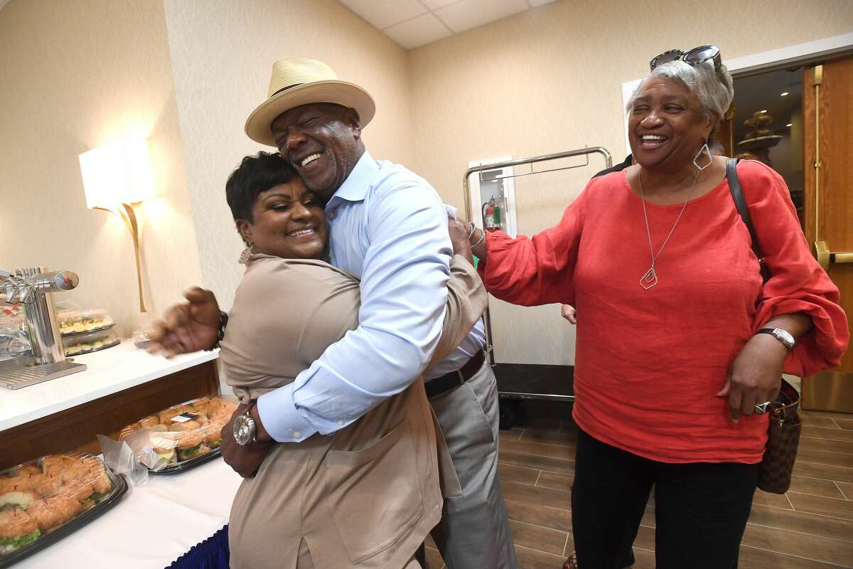 Robin Mouton gets a hug from her pastor Edison Colbert as he and wife Ava join in the celebration at her watch party in Beaumont's mayoral run-off election Saturday. Photo made Saturday, June 19, 2021 Kim Brent/The Enterprise