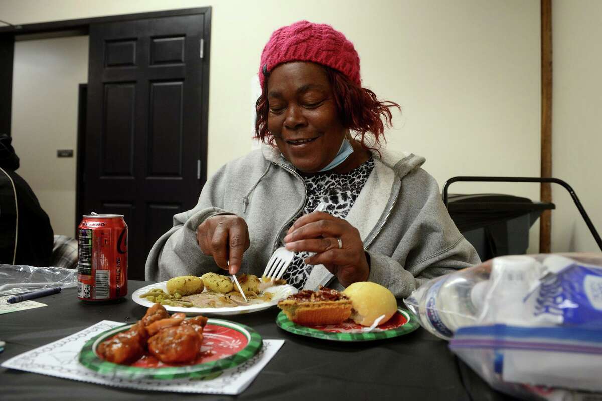 Mabel Bailey enjoys the holiday meal at Open Doors, in Norwalk, Conn. Dec. 23, 2021.