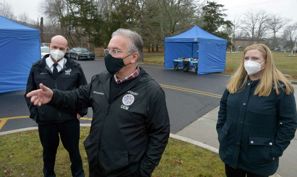 Mayor Dean Esposito, Health Director Kara Prunty, right, and Emergency Management Director Matthew Cassavechia, left, were at the SEMA4 testing site on Thursday where demand for tests has been high. They discussed test demand and the at-home kit distribution. Thursday, December 30, 2021, Danbury, Conn.