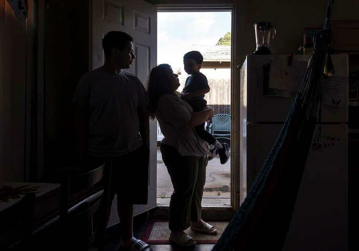 Ana with her children, Alejandro, 14, and Mateo, 4, in her garage apartment in Oakland. Ana applied for asylum in the U.S. after fleeing a gang in her native El Salvador. She was an attorney in her home country, and so far has seen her asylum hearing canceled twice and now faces a years-long wait until her new court date in 2025.