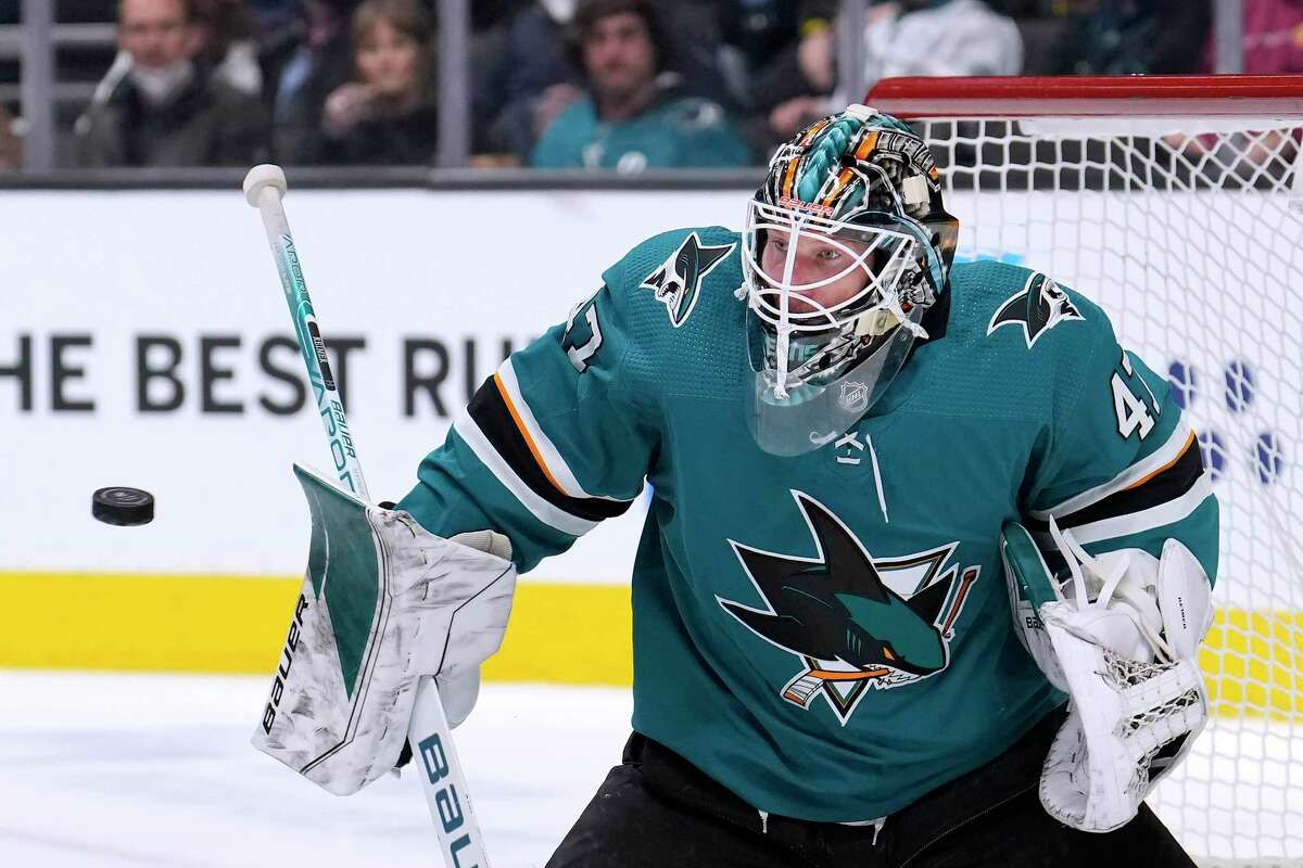 San Jose Sharks goaltender James Reimer blocks a shot by the Arizona Coyotes during the second period of an NHL hockey game Tuesday, Dec. 28, 2021, in San Jose, Calif. (AP Photo/Tony Avelar)