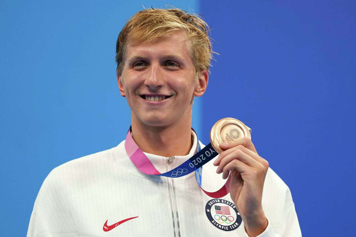 Kieran Smith, of the United States, holds his bronze medal from the men's 400-meter freestyle at the 2020 Summer Olympics, Sunday, July 25, 2021, in Tokyo, Japan. (AP Photo/Matthias Schrader)