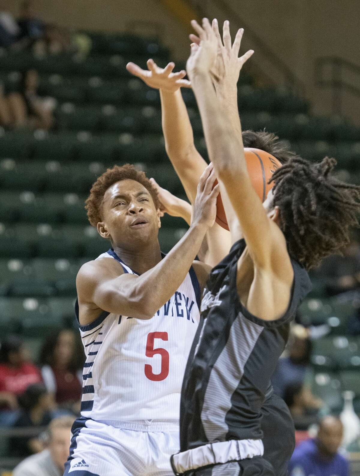 Plainview's Karomo Collins drives to the basket between Randall's Ayden Rodriguez and JJ Buchanan 12/30/2021 during the Byron Johnston Holiday Classic at the Chaparral Center. Tim Fischer/Reporter-Telegram