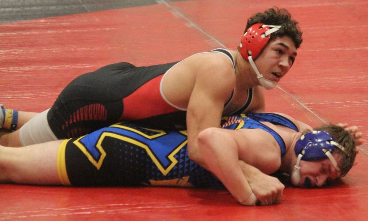 Reed City's Bryson Hughes (top) works against Evart's Sam Bailey during the holiday wrestling tournament at RCHS on Dec. 30, 2021.