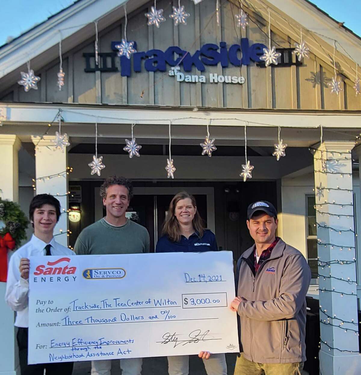 The staff of the Trackside Teen Center in Wilton send a big thank to the family owned heating oil company Santa Energy/Servco Oil and Propane company General Manager Stephen Santa for generously providing a $3,000 grant to the Trackside Teen Center through the Connecticut Neighborhood Association Act. Santa Energy’s donation will help Trackside begin work on a much-needed energy efficiency project at the center, replacing the many old windows, and doors in the historic Dana House, that is on the 15 Station Road property in Wilton. A photo from the receipt of the money, is shown.