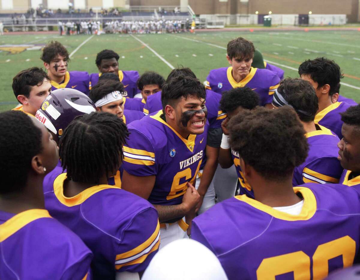 Senior captain Carlos Escobar leads his team in their first football game since the death of fellow teammate Jordan Martinez at Westhill High School in Stamford, Conn. Monday, Oct. 4, 2021. Martinez, a senior, died in a single car crash in Greenwich on Sept. 25. He was honored by fans and teammates at Westhill's game against Amity on Monday, the team's first game since his death.