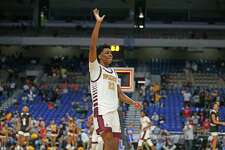 Dallas Kimball Alonzo Mitchell #23 acknowledges crowd after hitting winning three in OT. Beaumont United vs. Dallas Kimball in Class 5A state championship at the Alamodome on Friday, 2021