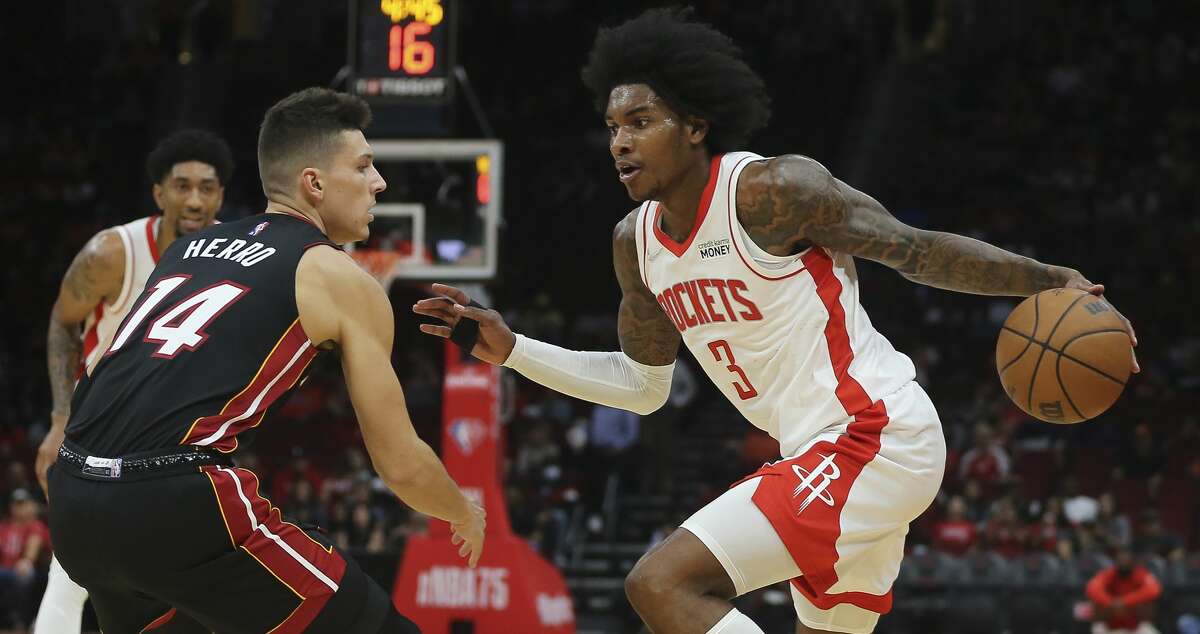 Houston Rockets guard Kevin Porter Jr. (3) tries to dribble past Miami Heat guard Tyler Herro (14) during the first quarter of a NBA preseason game Thursday, Oct. 7, 2021, at Toyota Center in Houston.