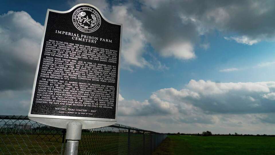 A historical marker denotes the Imperial Prison Farm Cemetery, Thursday, Dec. 9, 2021, in Sugar Land. The existing cemetery is not far from where human remains were found during the construction of Fort Bend ISD's James Reese Career and Technical Center in 2018.