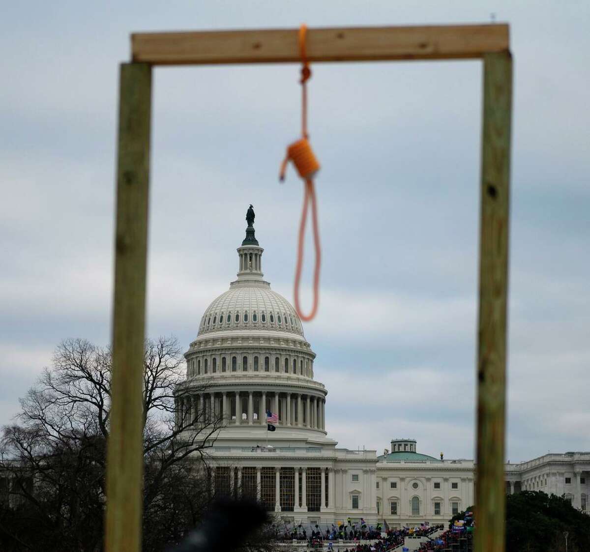 A noose hangs on a makeshift gallows outside the U.S. Capitol on Jan. 6, 2021. Polls show 71% of Republicans now view Biden’s election as illegitimate. Nearly as many see view the Capitol insurrectionists as lawful “protesters.”