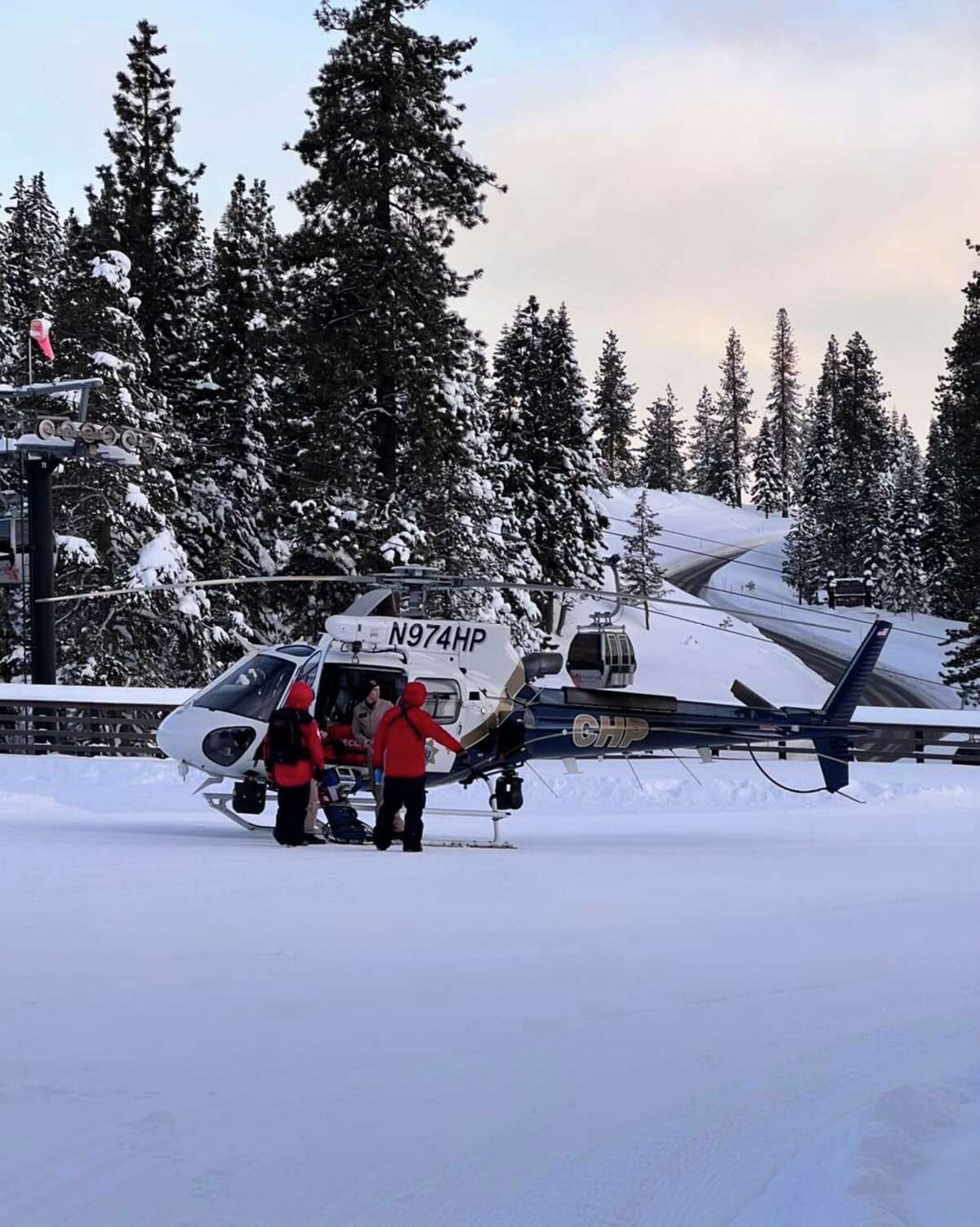 This photograph shows rescue crews with a helicopter that was used to search for Truckee resident Rory Angelotta, 43, who went missing at Northstar California Resort during a blizzard on Christmas Day. Rescue search operations the skier are being suspended, with authorities saying on Thursday that there is “no realistic possibility” he could have survived the severe storm conditions in the Sierra.
