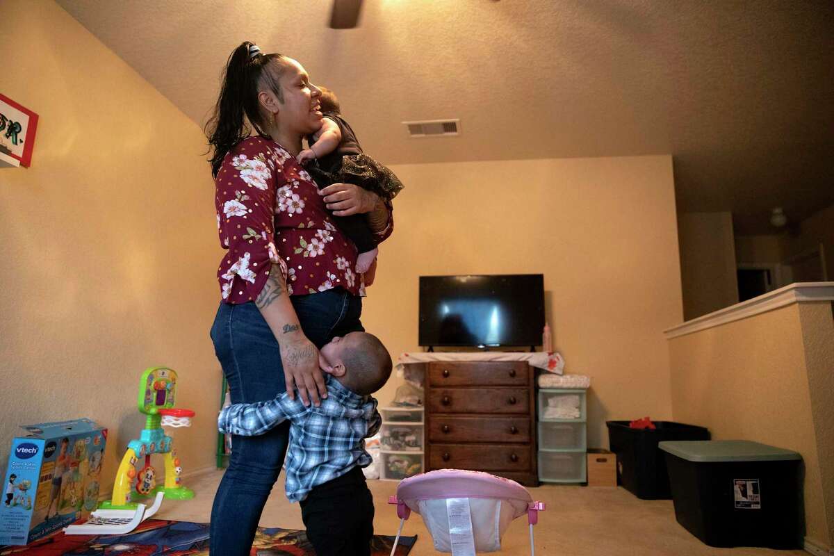Melinda Longoria holds her 4-month old daughter, Annistey, while her toddler son, Manuel, cries out for her. Longoria and Manuel were recently reunited after he was taken from her custody while she battled drug addiction. She has been clean and sober since May.