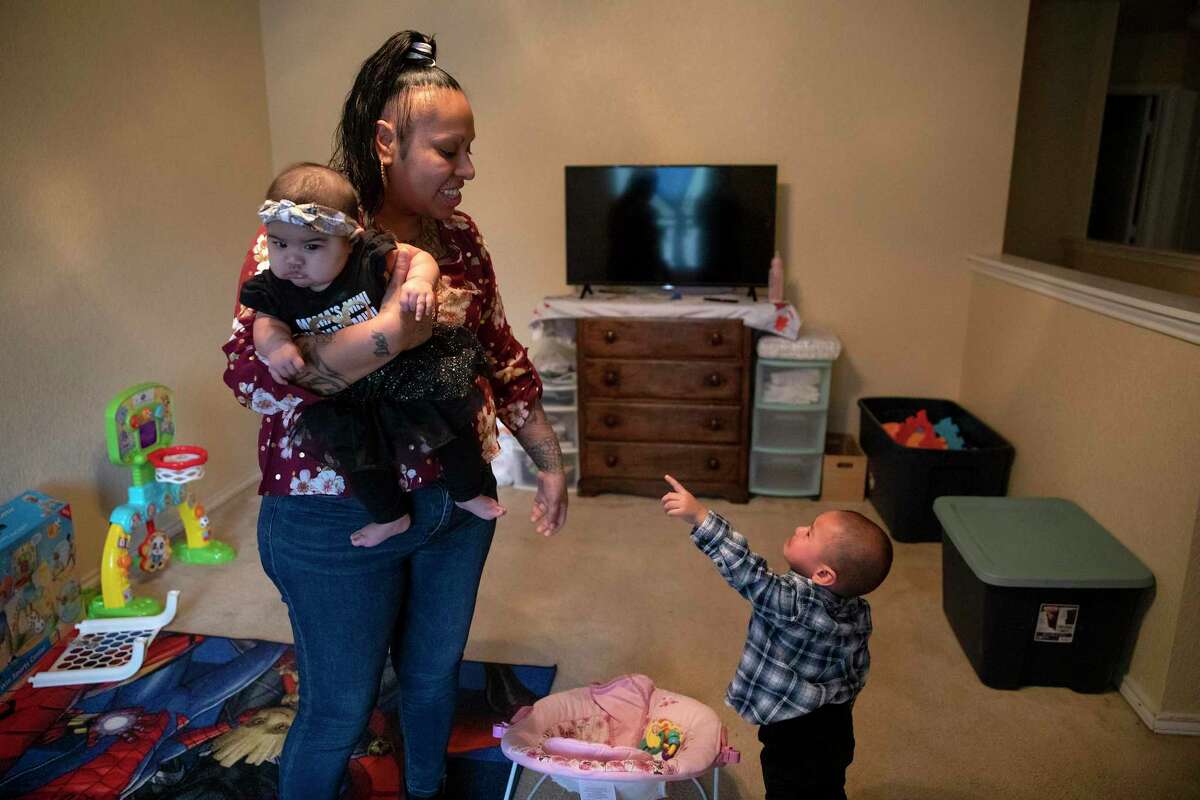 Melinda Longoria holds her 4-month old daughter, Annistey, while her toddler son, Manuel, cries out for her. Longoria and Manuel were recently reunited after he was taken from her custody while she battled drug addiction. She has been clean and sober since May.