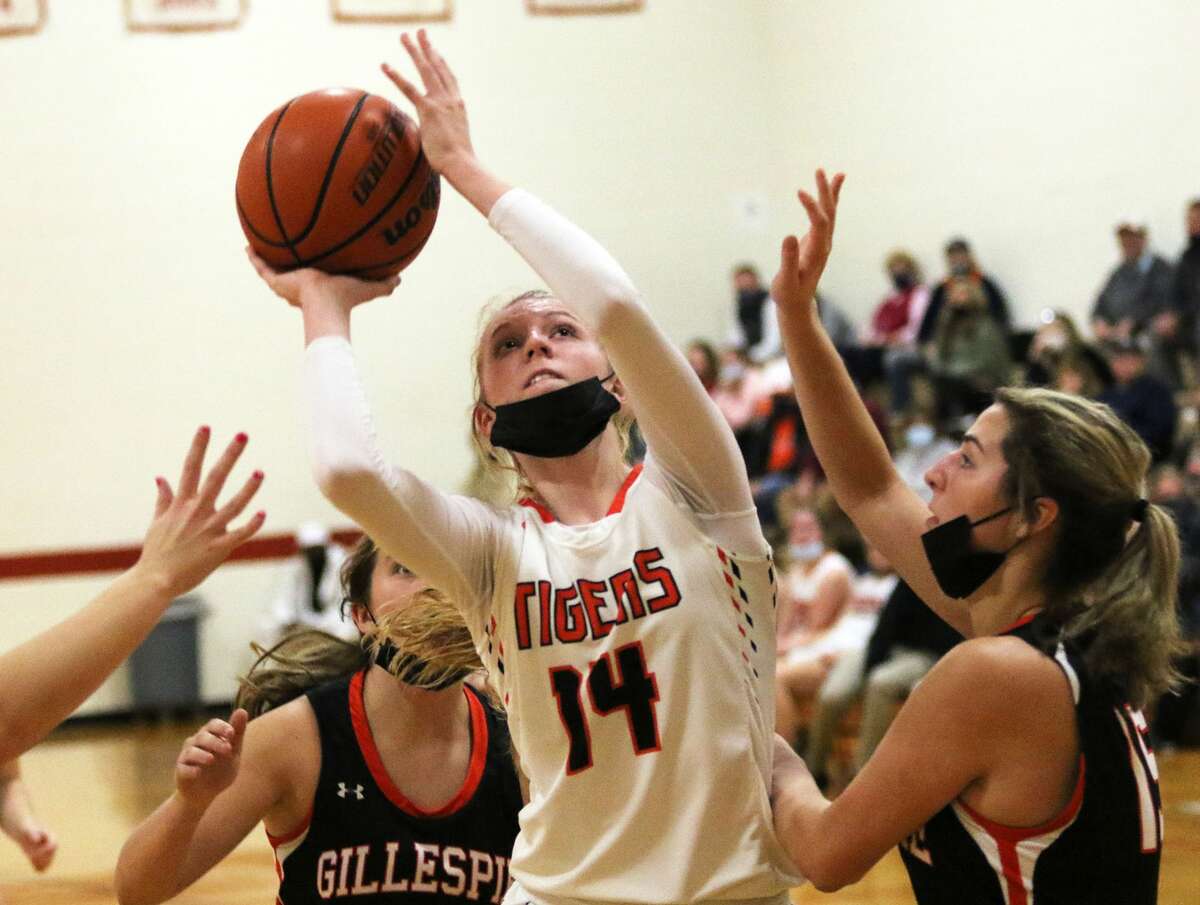 Greenfield's Alexis Pohlman (14) puts up a shot in the middle of Gillespie defenders Monday at the Carlinville Tourney. On Thursday, Pohlman scored 27 points in the Tigers' title-game loss to Williamsville.