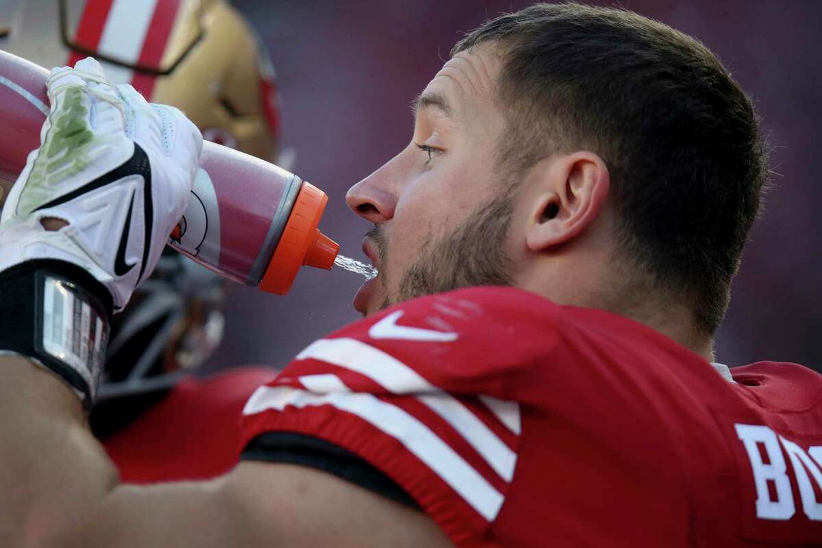 San Francisco 49ers defensive end Nick Bosa (97) drinks Gatorade on the sideline during an NFL football game against the Atlanta Falcons, Sunday, Dec. 19, 2021, in Santa Clara, Calif. (AP Photo/Scot Tucker)