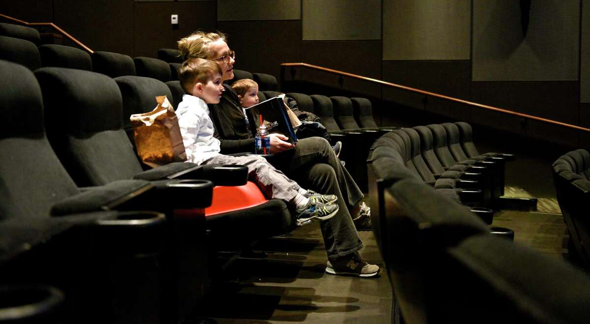 Leah Wiener, of Ridgefield, and her sons Max, 5, and Owen, 3, previously wait for a movie to start at the Prospector Theater in Ridgefield, in a recent year. Here is a list of the latest movies, and movie times that are playing at one of the entertainment venues in the town from, New Year’s Eve, Friday, December 31, 2021, all the way through to Thursday, January 6, 2022.