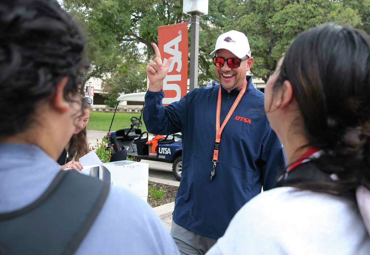 UTSA football coach Jeff Traylor (center) and his guest Brenda Tracy hands out Tiff Treats cookies to students for "Game Week Wednesday" at the main campus on Wednesday, Nov. 10, 2021. They were also there to encourage students to take the "Set the Expectation Pledge" to stand up against sexual and interpersonal violence. This week's home football game against Southern Miss will promote Tracy's campaign for athletic programs to not tolerate sexual assault or interpersonal violence with the ranks of athletic programs. Tracy is a survivor of rape. UTSA was amongst of the first school's in the country to adopt the Tracy Rule.