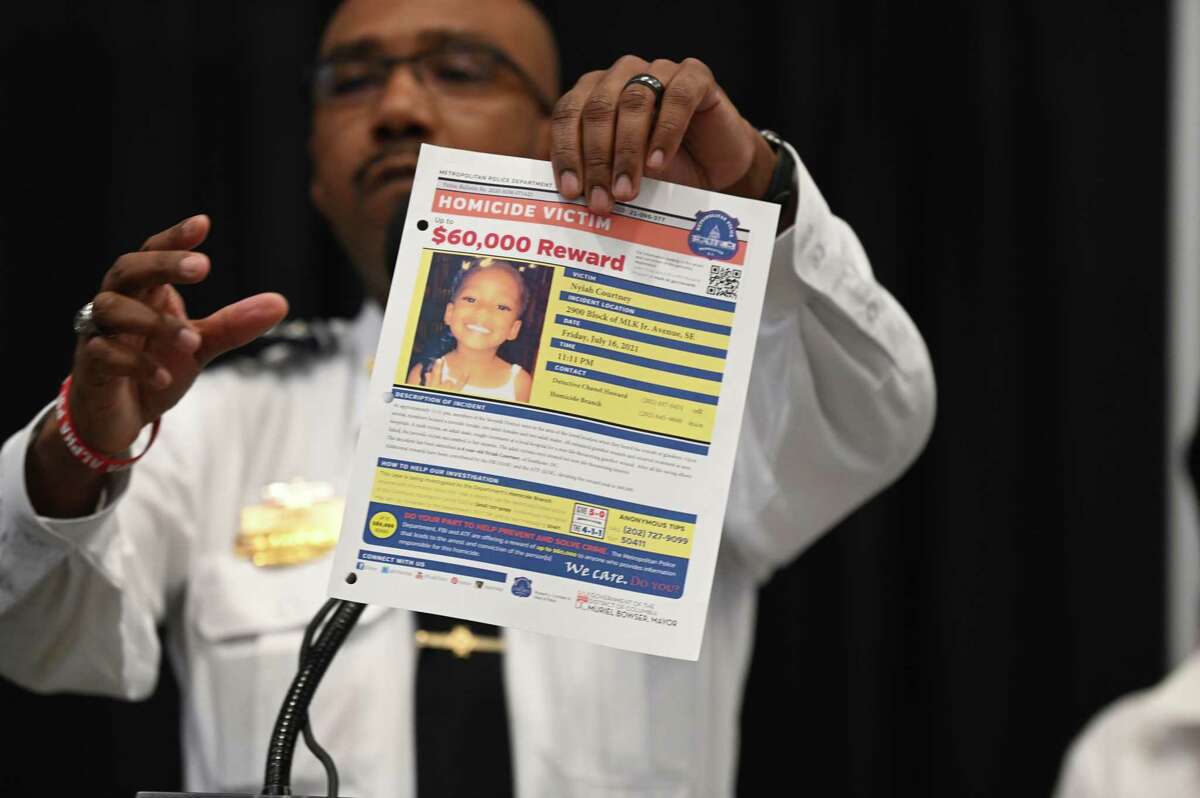 D.C. Police Chief Robert Contee holds up a poster requesting information in the shooting death of 6-year-old Nyiah Courtney.