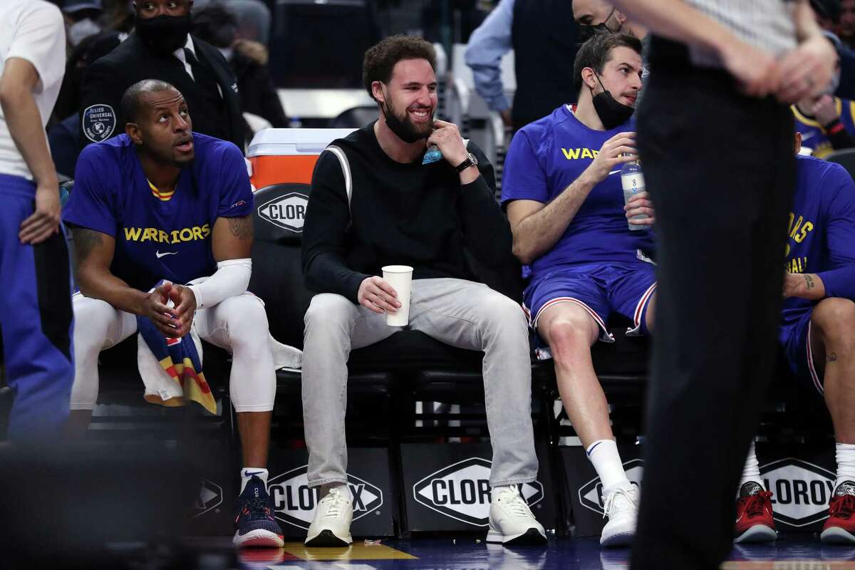 Golden State Warriors' Klay Thompson enjoys himself on the bench in 2nd quarter of Denver Nuggets' 89-86 win in NBA game at Chase Center in San Francisco, Calif., on Tuesday, December 28, 2021.