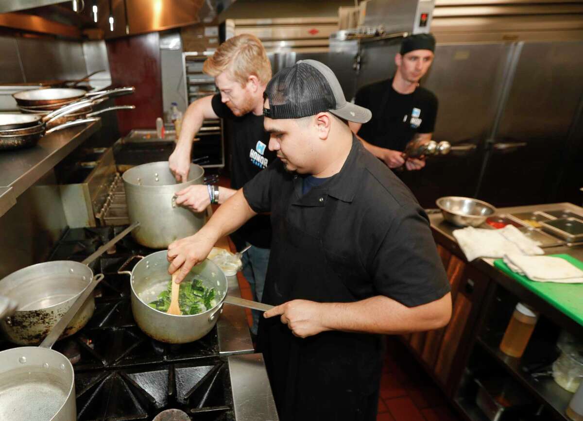Oscar Sandoval prepares a Plablano sauce as guest rang in the New Year with a four-course meal at Honor Cafe, Friday, Dec. 31, 2021, in Conroe.