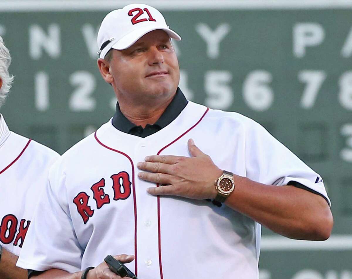 Former Boston Red Sox pitcher Roger Clemens pats his chest to cheering fans during a ceremony prior to a baseball game between the Red Sox and the Seattle Mariners at Fenway Park in Boston on Tuesday, July 30, 2013. The Red Sox are celebrating the 25th anniversary of a streak in 1988 that began after Joe Morgan became manager of the team. (AP Photo/Elise Amendola) ORG XMIT: MAEA106