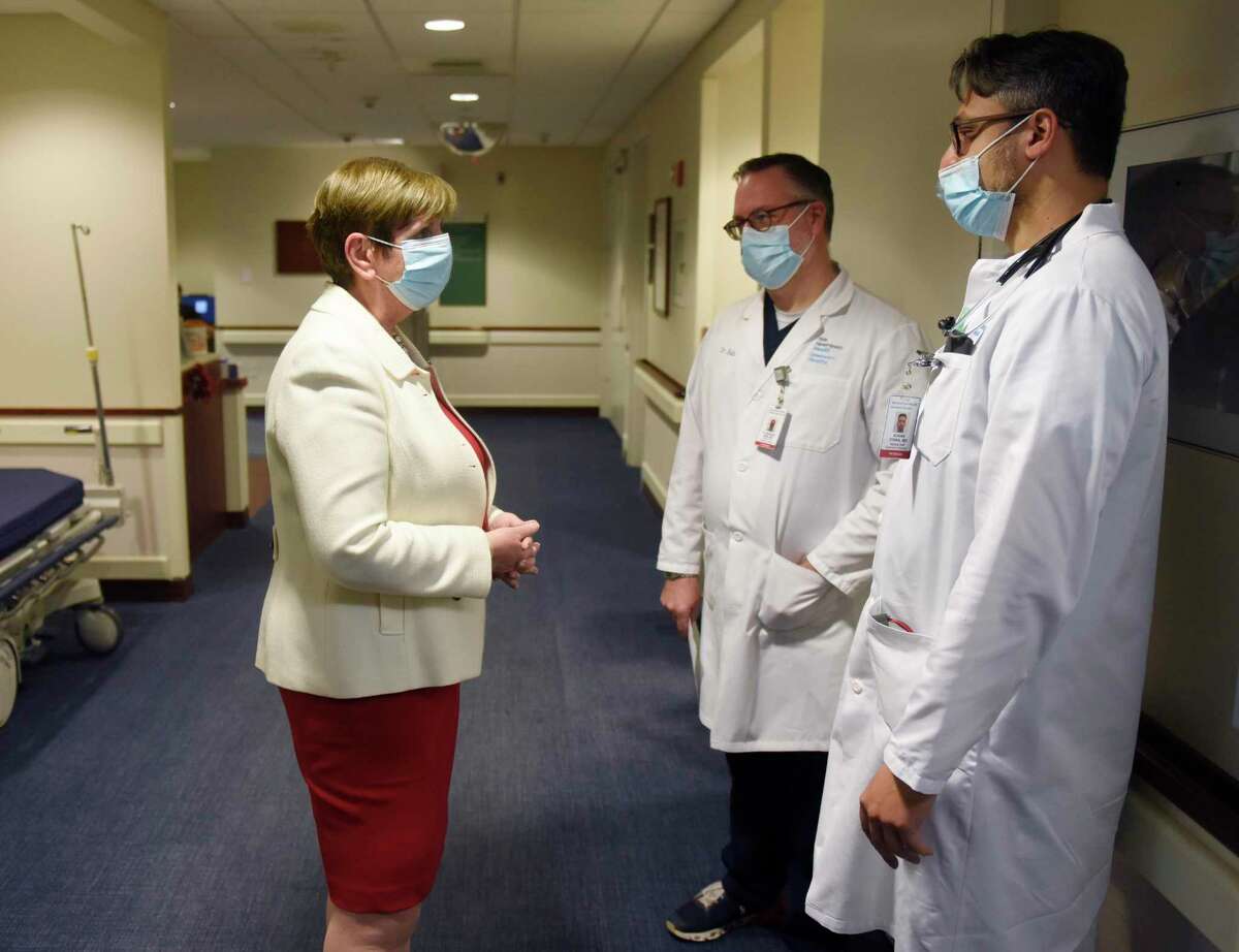 Greenwich Hospital President and COO Diane Kelly, left, chats with Dr. R. Morgan Bain, center, and Dr. Adnan Diwan at Greenwich Hospital in Greenwich, Conn. Tuesday, Dec. 21, 2021.