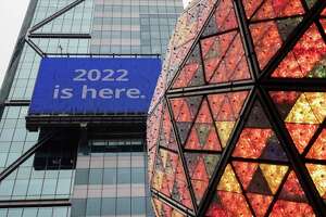 A sign reading ""2020 is here." Is seen with New Year's Eve Ball during the New Year's Eve Ball Test at Times Square on Thursday, Dec. 30, 2021, in New York. New York City will ring in 2022 in Times Square as planned despite record numbers of COVID-19 infections in the city and around the nation, Mayor Bill de Blasio said Thursday.  (AP Photo/Yuki Iwamura)