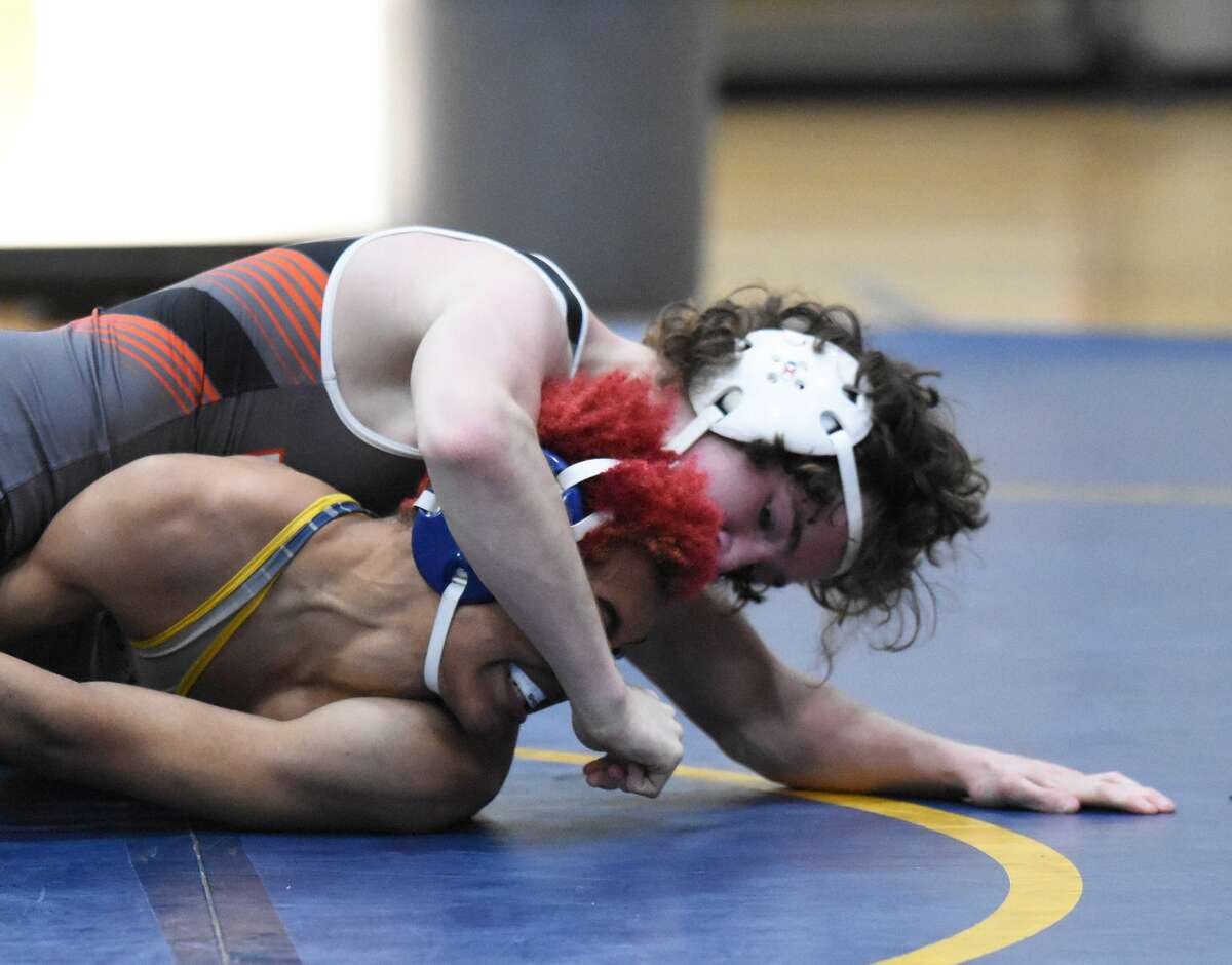 Edwardsville's Nathan Hollis locks in a hold in his match against the O'Fallon Panthers on Thursday in O'Fallon.