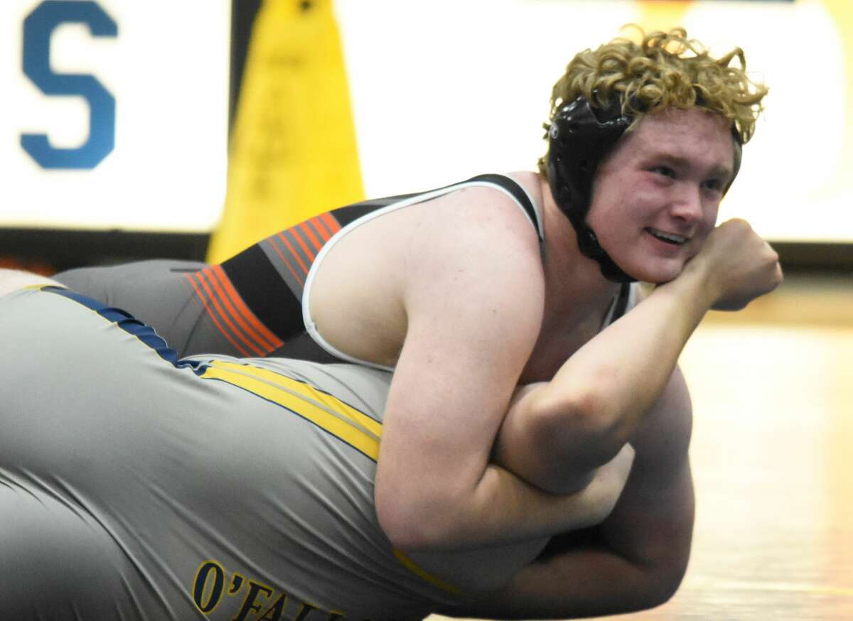 Edwardsville's Cliff Seaman smiles as he earns the pin at 220 pounds against the O'Fallon Panthers on Thursday in O'Fallon.