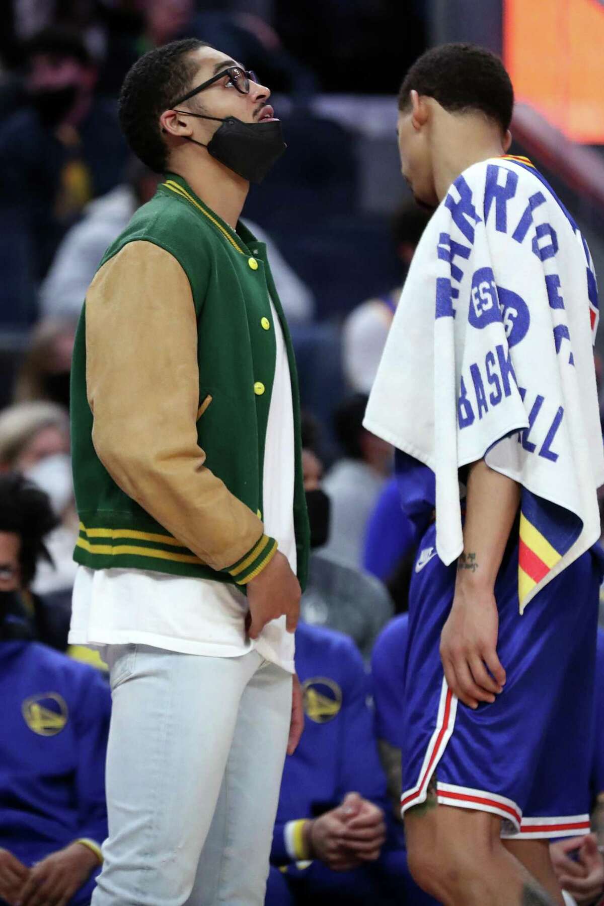 Golden State Warriors' Jordan Poole watches a replay in 4th quarter of Denver Nuggets' 89-86 win in NBA game at Chase Center in San Francisco, Calif., on Tuesday, December 28, 2021.